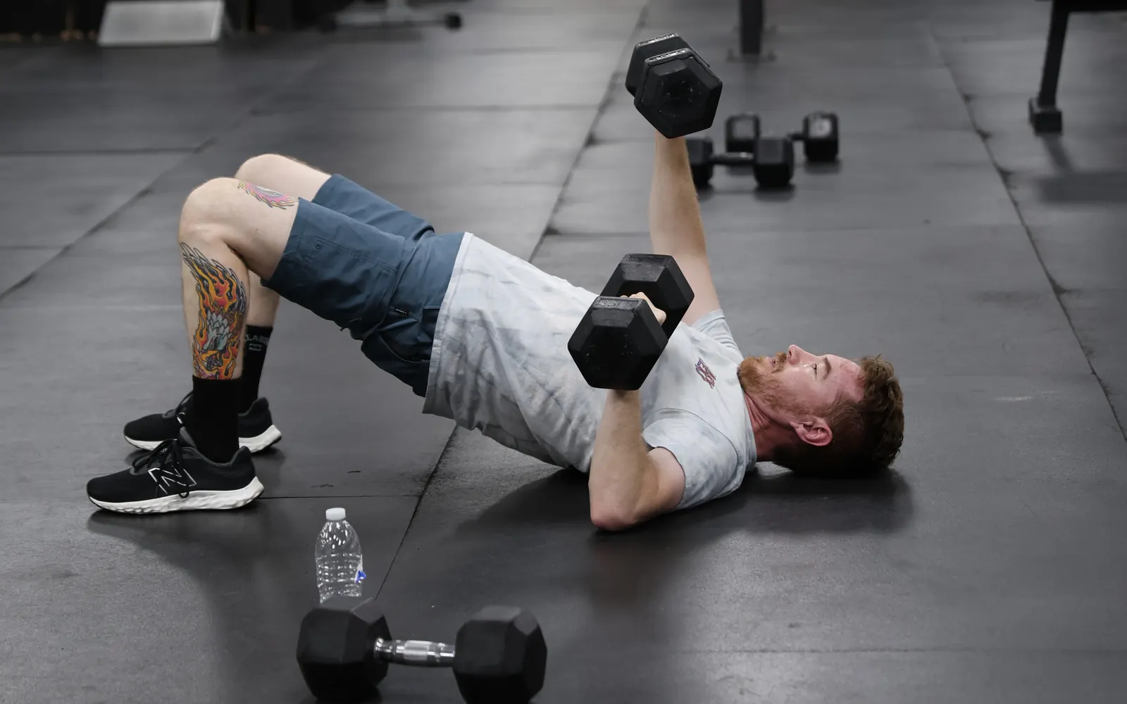 Member doing a dumbbell floor press